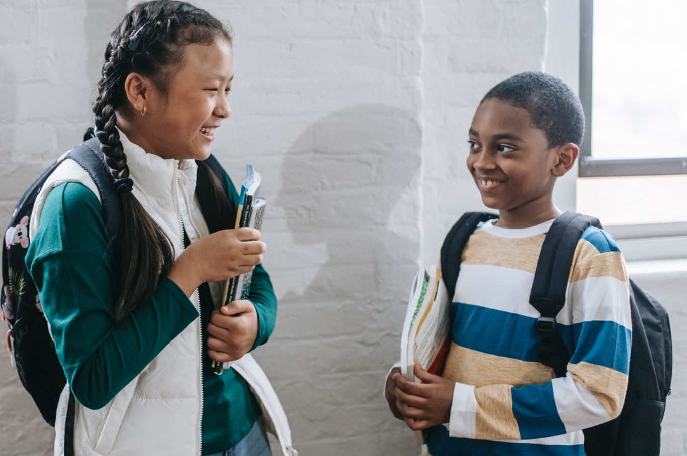 children wearing backpacks